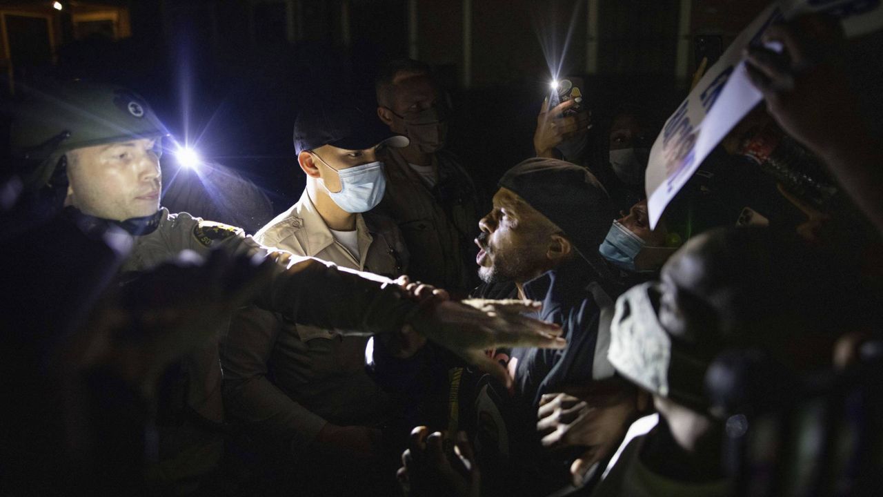 Protesters clash with deputies of the L.A. Sheriff's Department during protests on August 31, 2020, following the death of Dijon Kizzee, a 29-year-old Black man. (AP Photo/Christian Monterrosa)