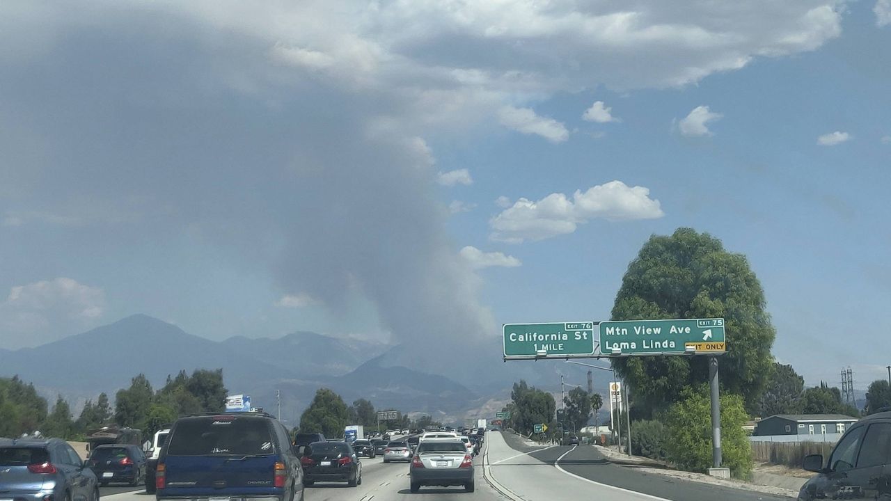 A plume of smoke from the El Dorado fire is seen from the Interstate 10 in Loma Linda, Calif., Saturday, Sept. 5, 2020. (AP Photo/Ringo H.W. Chiu)