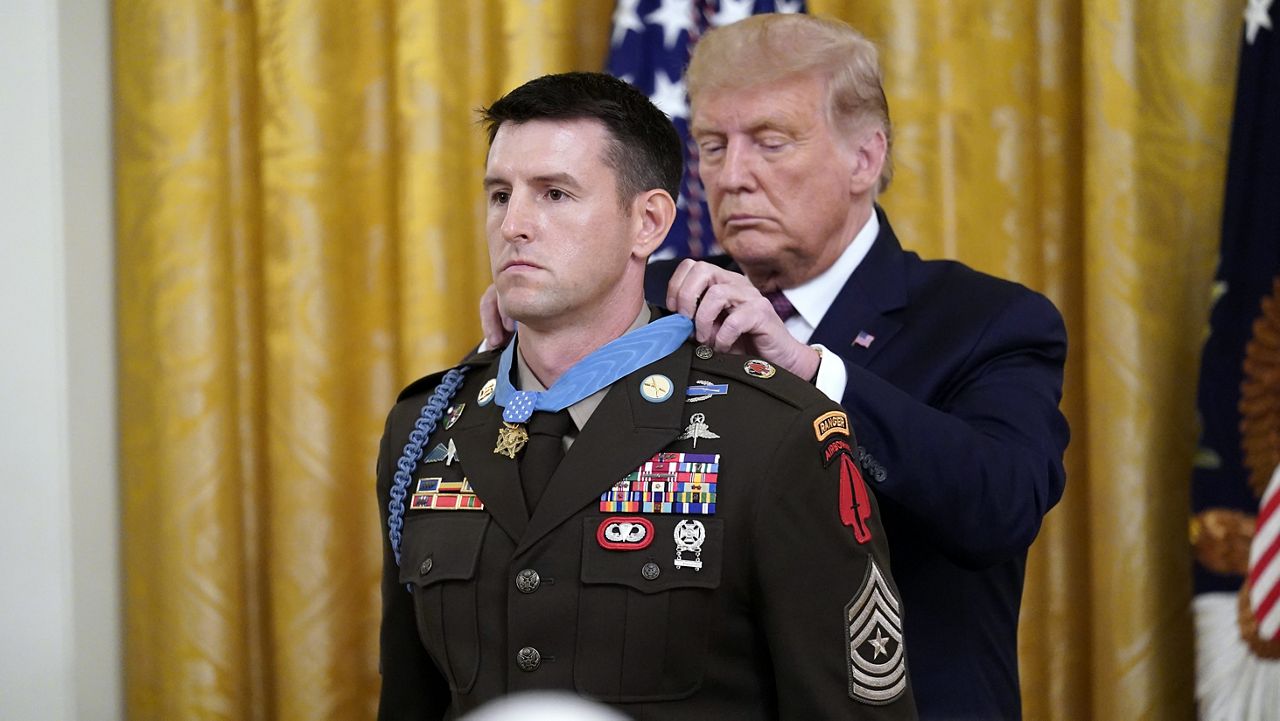 President Donald Trump awards the Medal of Honor to Army Sgt. Maj. Thomas P. Payne in the East Room of the White House on Friday, Sept. 11, 2020, in Washington. (AP Photo/Andrew Harnik)
