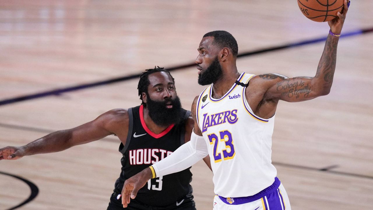 LeBron James is defended by James Harden during the first half of the NBA conference semifinal playoff game Saturday, Sept. 12, 2020. (AP Photo/Mark J. Terrill)