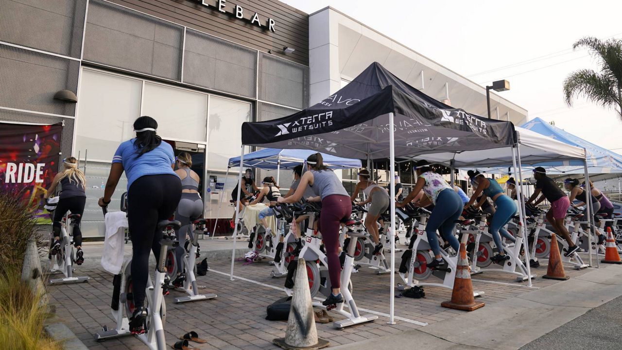 A fitness class is held in the parking lot outside CycleBar, Sept. 15, 2020, in Culver City, Calif. (AP/Chris Pizzello)