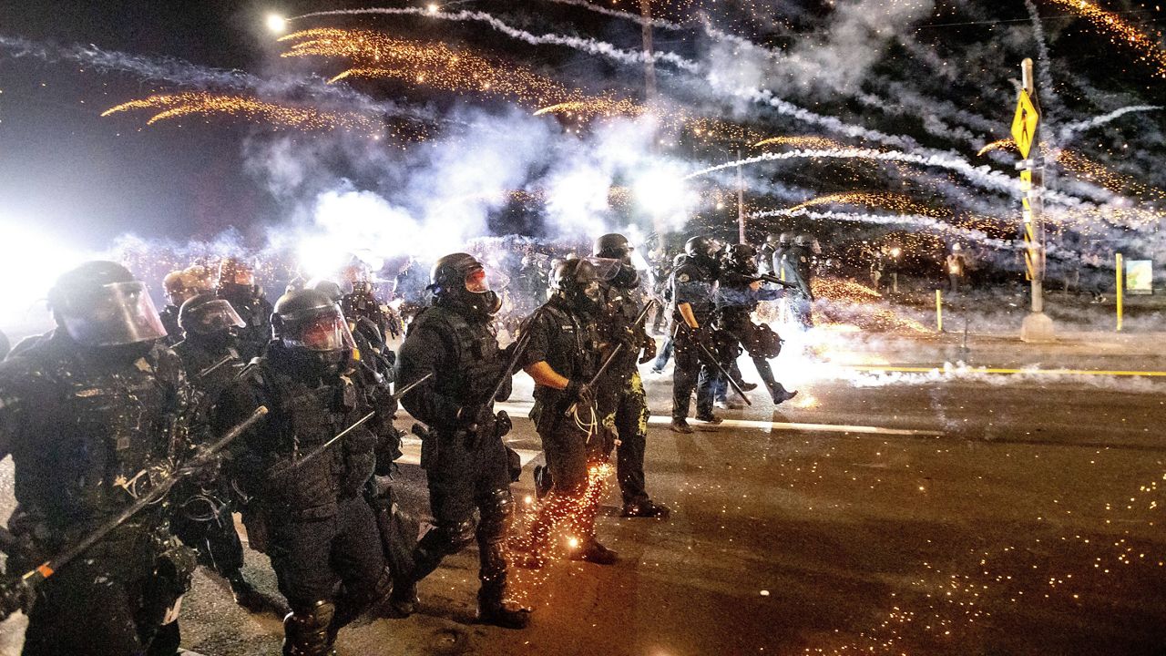 In this Sept. 5, 2020 file photo, police use chemical irritants and crowd control munitions to disperse protesters during a demonstration in Portland, Ore. (AP Photo/Noah Berger, File)