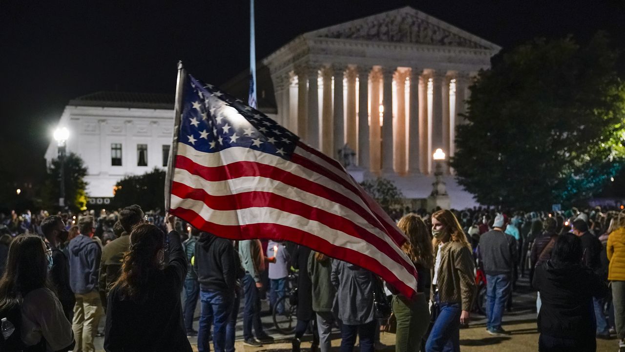 People gather at the Supreme Court in Washington, Saturday night, Sept. 19, 2020, to honor the late Justice Ruth Bader Ginsburg, one of the high court's liberal justices, and a champion of gender equality.  (AP Photo/J. Scott Applewhite)