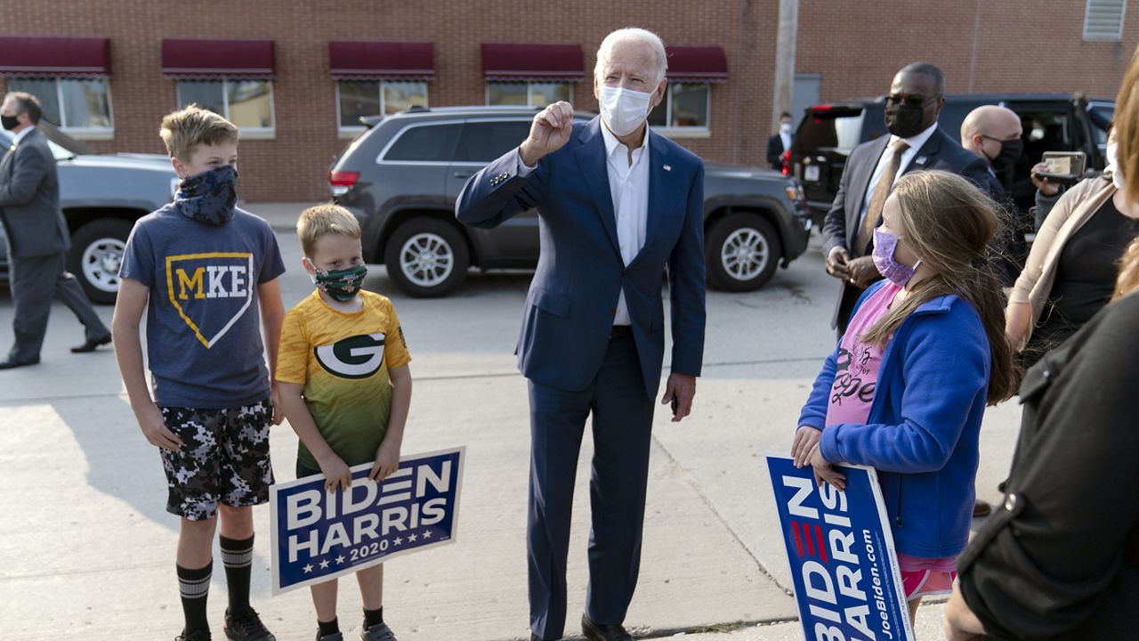 Democratic presidential candidate former Vice President Joe Biden greets supporters outside of the Wisconsin Aluminum Foundry in Manitowoc, Wis., Monday, Sept. 21, 2020. (AP Photo/Carolyn Kaster)