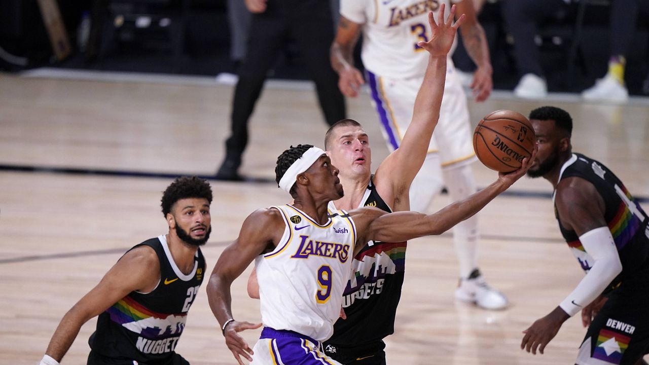 Los Angeles Lakers guard Rajon Rondo (9) goes up for a shot as Denver Nuggets' Jamal Murray, left, Nikola Jokic, center, and Paul Millsap, right, defend during the first half of Game 3 of the NBA basketball Western Conference final Tuesday, Sept. 22, 2020, in Lake Buena Vista, Fla. (AP Photo/Mark J. Terrill)