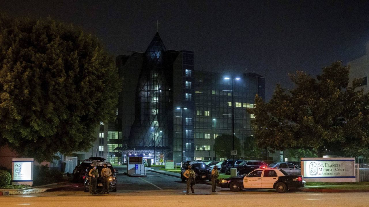 In this Sept. 13, 2020 photo, L.A. County Sheriff's deputies guard the entrance to St. Francis Medical Center after two deputies were shot on Sept. 12 while sitting inside their patrol vehicle guarding a Metro station in Compton, Calif. (AP/Jintak Han)