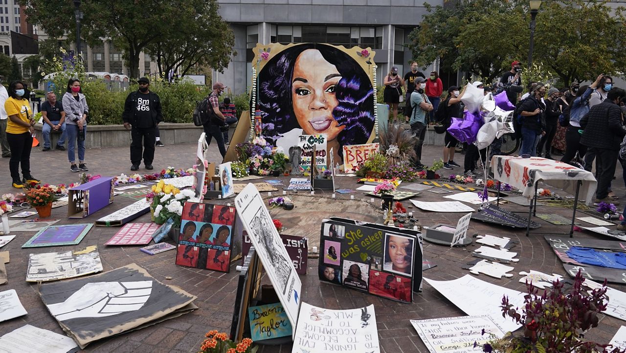 FILE - In this Wednesday, Sept. 23, 2020, file photo, people gather in Jefferson Square in Louisville, awaiting word on charges against police officers in the death of Breonna Taylor. (AP Photo/Darron Cummings, File)