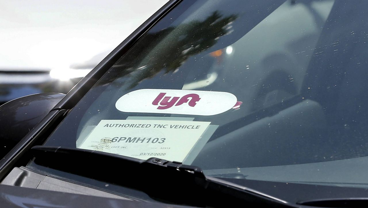 A Lyft ride-share car waits at a stoplight in Sacramento, Calif. (AP Photo/Rich Pedroncelli, File)