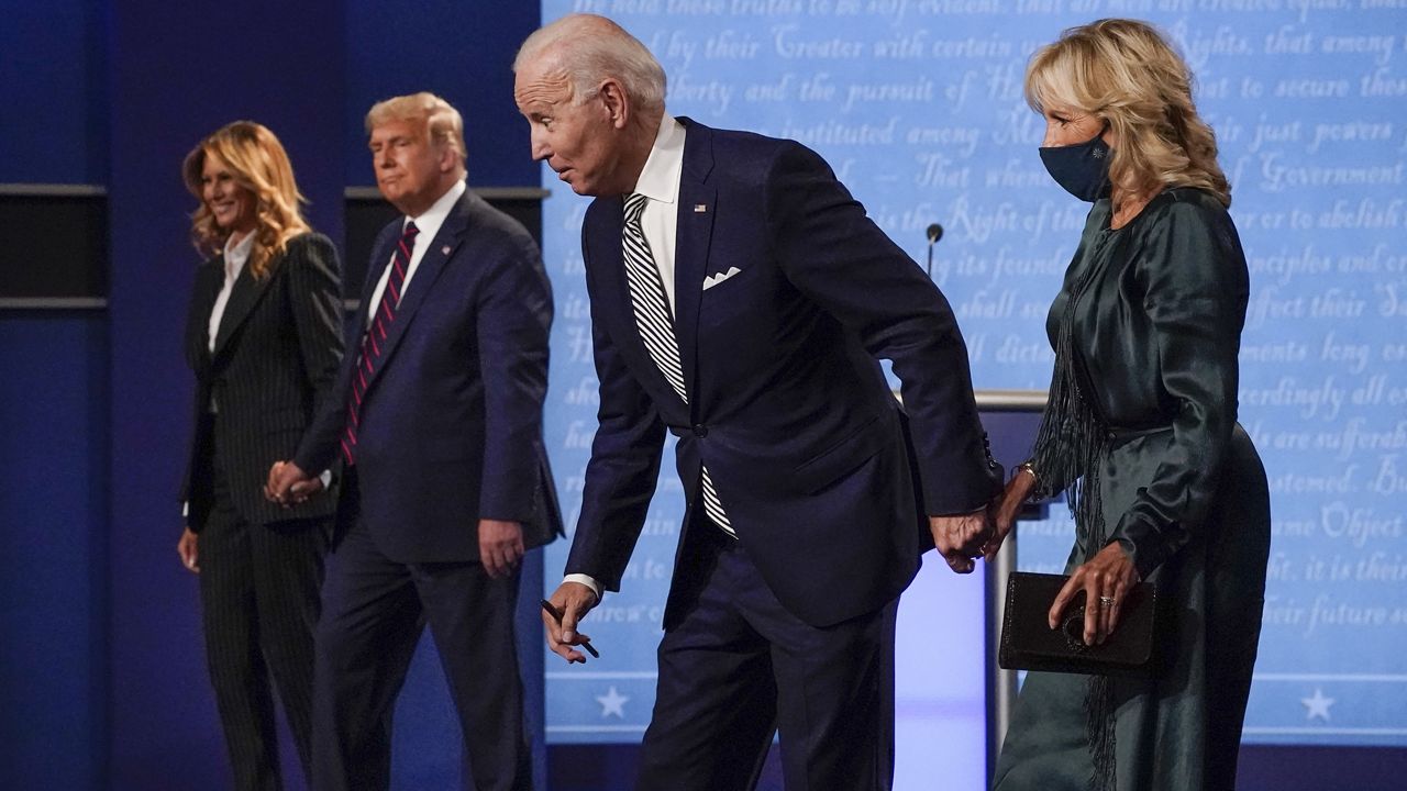 First lady Melania Trump, from left, President Donald Trump, Democratic presidential candidate former Vice President Joe Biden and Jill Biden stand on stage after the first presidential debate at Case Western University and Cleveland Clinic, in Cleveland, Ohio, Sept. 29, 2020. (AP Photo/Julio Cortez)