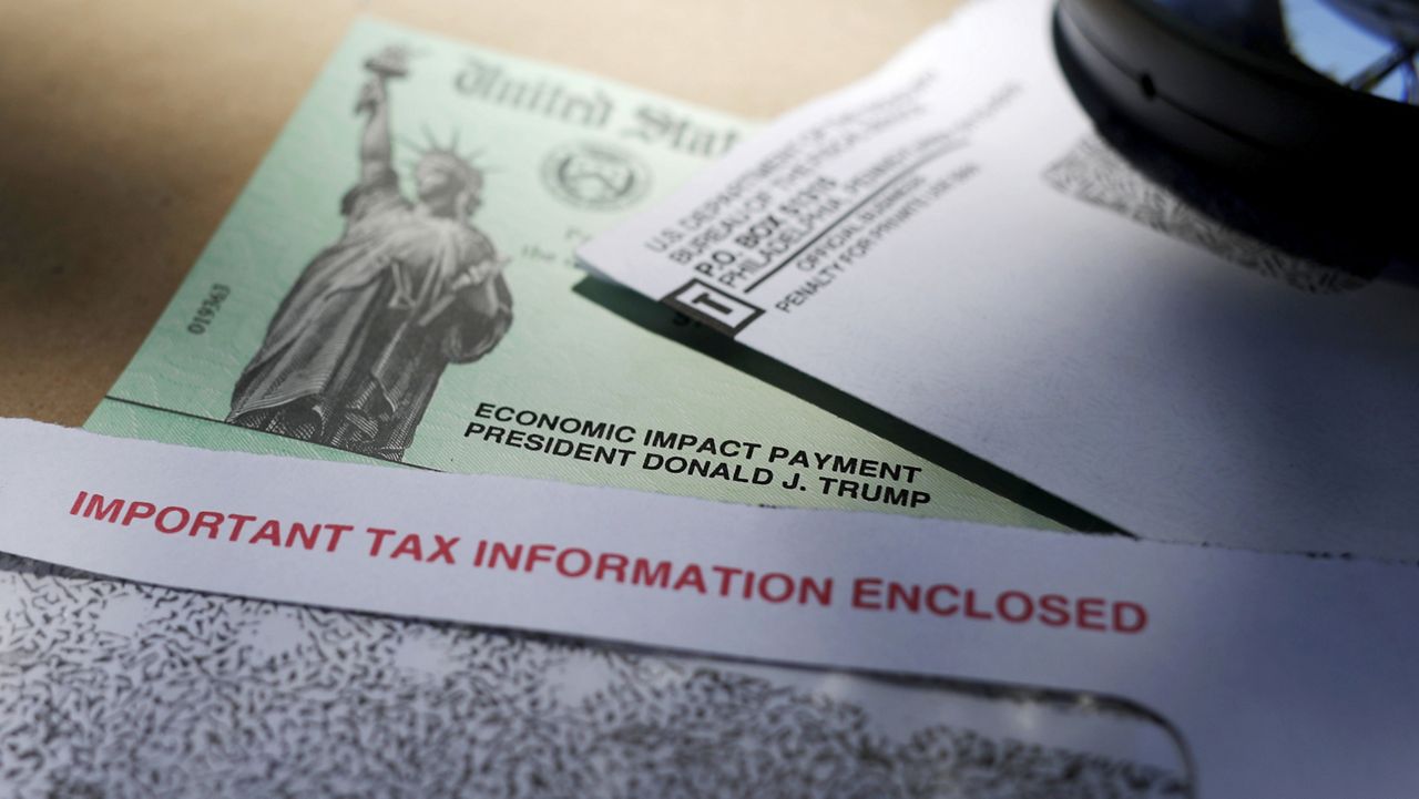 In this April 23, 2020, file photo, President Donald Trump's name is seen on a stimulus check issued by the IRS to help combat the adverse economic effects of the COVID-19 outbreak. (AP Photo/Eric Gay, File)