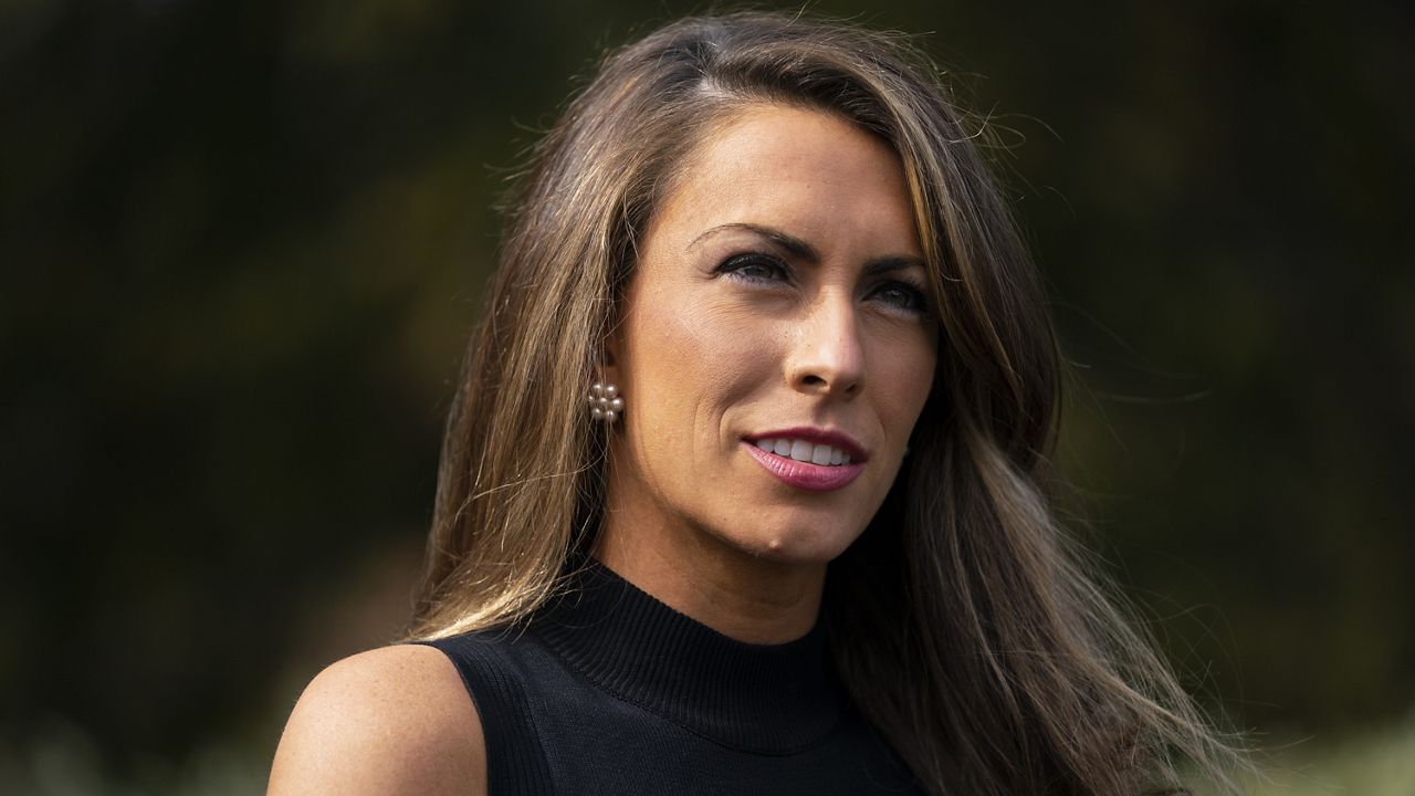 White House communications director Alyssa Farah talks to reporters outside the White House, Friday, Oct. 9, 2020, in Washington. (AP Photo/Evan Vucci)