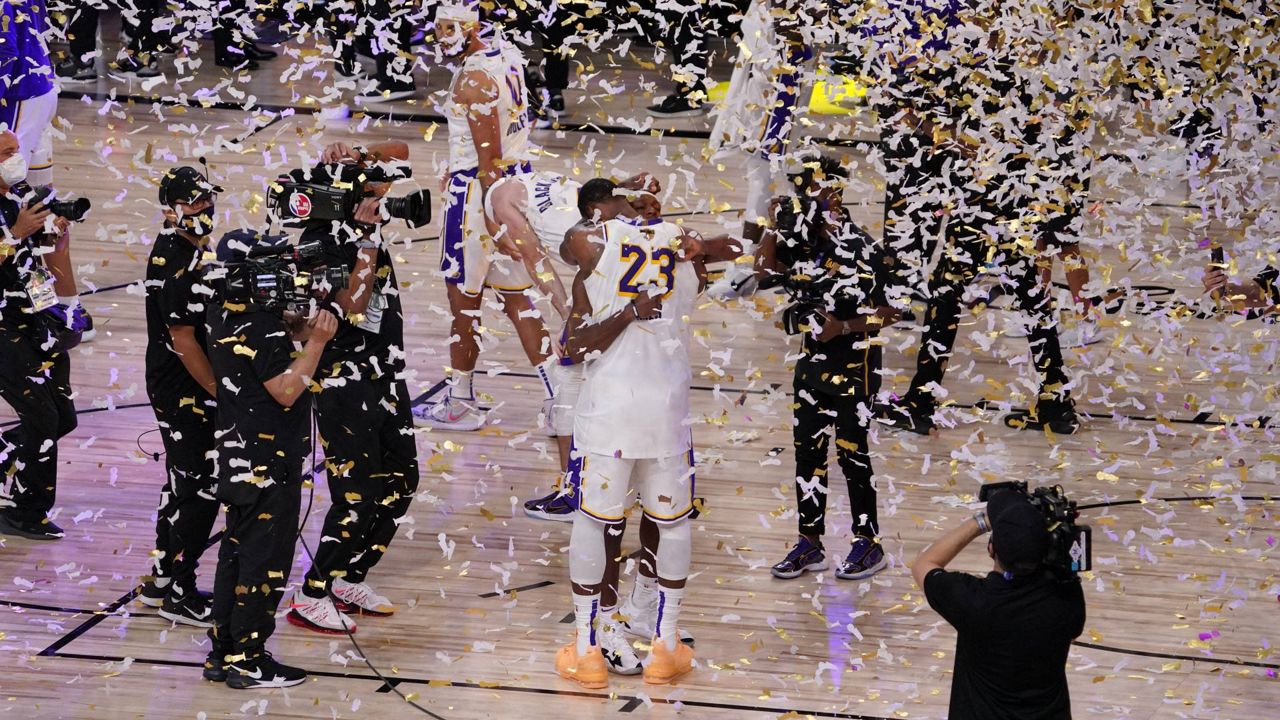 The Los Angeles Lakers players celebrate after the Lakers defeated the Miami Heat 106-93 in Game 6 of basketball's NBA Finals Sunday, Oct. 11, 2020, in Lake Buena Vista, Fla. (AP Photo/Mark J. Terrill)