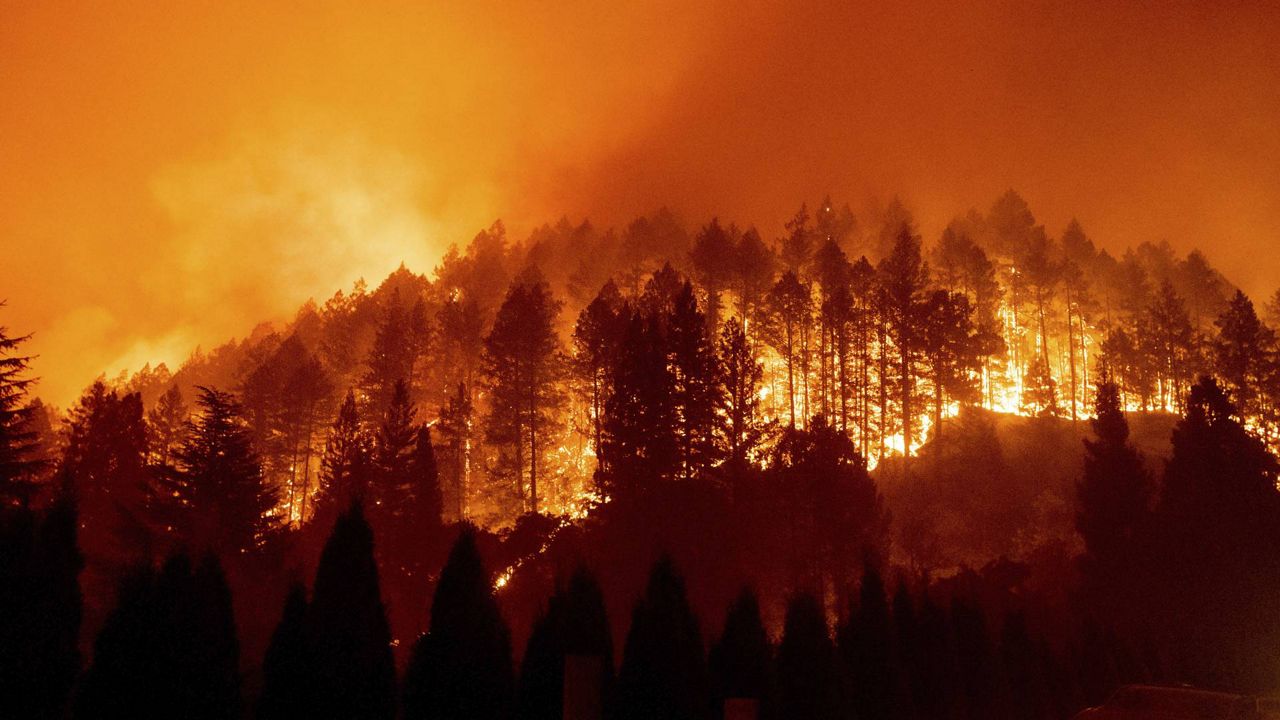 In this Sept. 27, 2020 photo, the Glass Fire burns a hillside above Silverado Trail in St. Helena, Calif. (AP/Noah Berger)