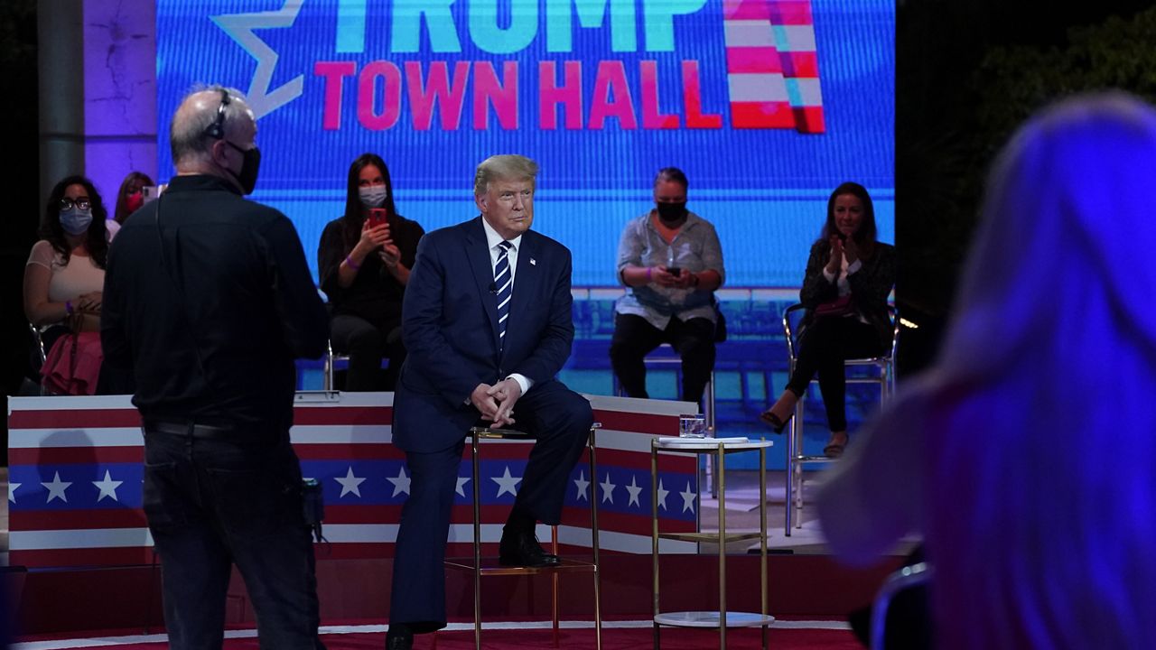 President Donald Trump sits during a break in an NBC News Town Hall, at Perez Art Museum Miami, Thursday, Oct. 15, 2020, in Miami. (AP Photo/Evan Vucci)