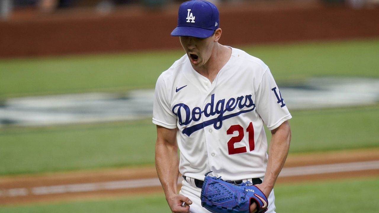 Los Angeles Dodgers starting pitcher Walker Buehler celebrates after striking out Atlanta Braves' Austin Riley during the sixth inning in Game 6 of a baseball National League Championship Series Saturday, Oct. 17, 2020, in Arlington, Texas. (AP Photo/Eric Gay)