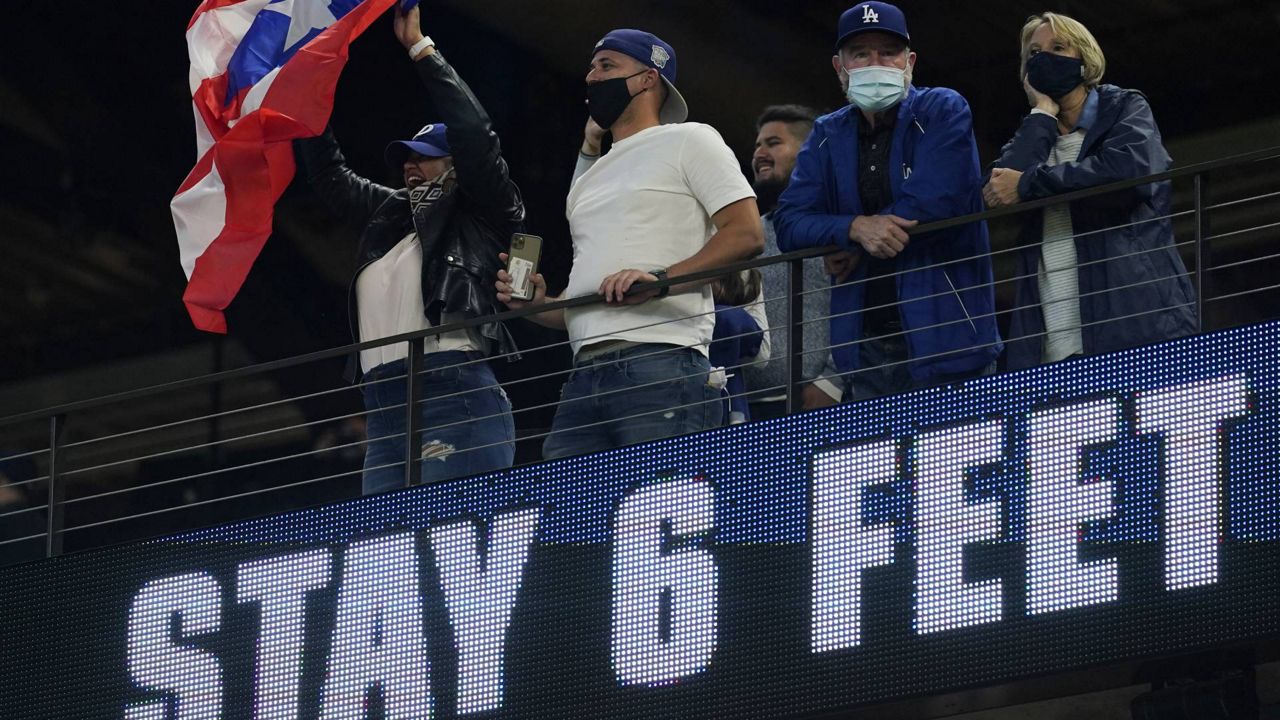 Dodgers fans watch during batting practice before Game 3 of the World Series Friday, Oct. 23, 2020, in Arlington, Texas. (AP/Eric Gay)