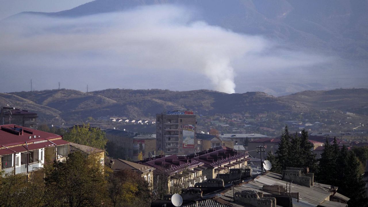 Smoke rises after shelling by Azerbaijan's artillery during a military conflict in Stepanakert, the separatist region of Nagorno-Karabakh, Saturday, Oct. 24, 2020. (AP Photo)