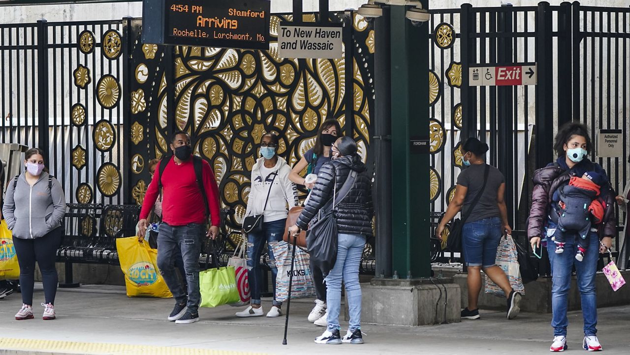 File Photo - People wearing protective masks during the coronavirus pandemic wait for a train at the Fordham Metro North station Thursday, Oct. 22, 2020, in New York. (AP Photo/Frank Franklin II)