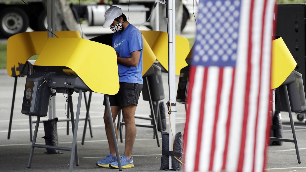 In this May 12, 2020, file photo, Arjan Walia votes during a special election in Santa Clarita, Calif. Most vote centers in California will open on Saturday.  (AP Photo/Marcio Jose Sanchez, File)