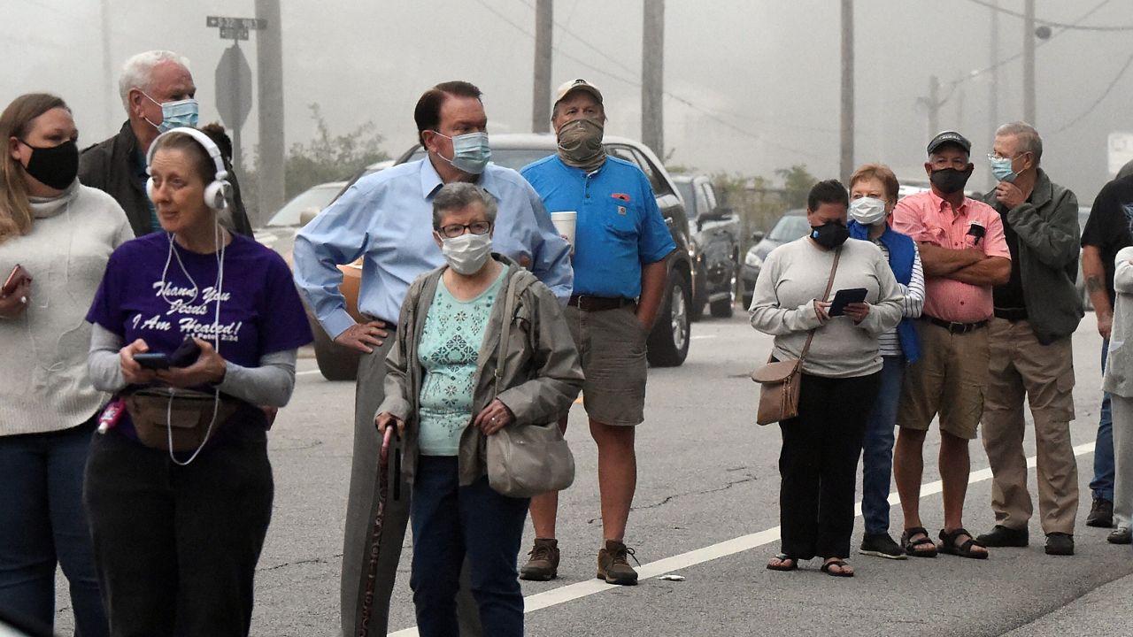 Voters line up to cast in-person absentee ballots on Tuesday, Oct. 27, 2020, in West Columbia, S.C. (AP Photo/Meg Kinnard)