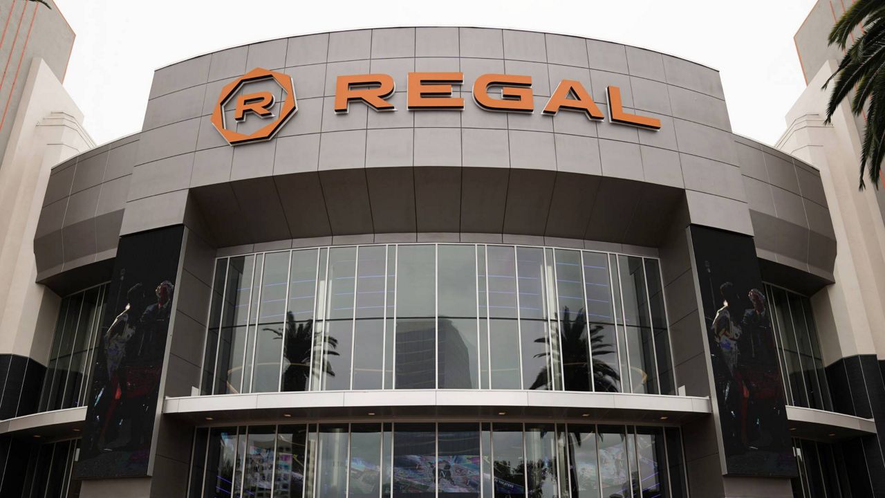 Shoppers walk past a Regal movie theater in Irvine, Calif., on Sept. 8, 2020. (AP Photo/Jae C. Hong, File)