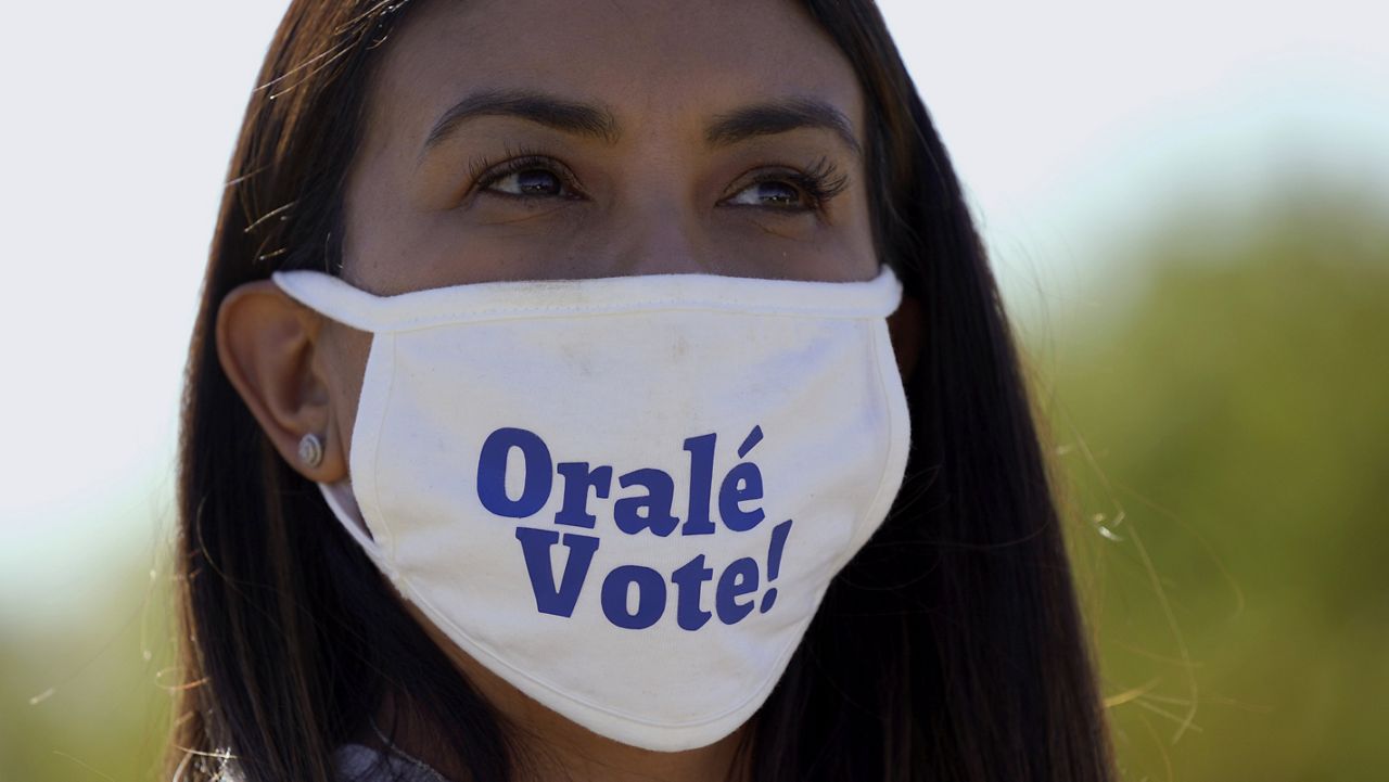 A supporter of Democratic vice presidential candidate Sen. Kamala Harris, D-Calif., listens to her speak at a campaign event Friday, Oct. 30, 2020, in Fort Worth, Texas. (AP Photo/LM Otero)