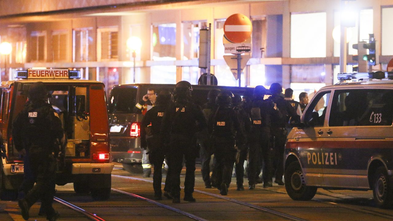 Police officers walk between emergency vehicles at the scene after gunshots were heard, in Vienna, Monday, Nov. 2, 2020. (Photo/Ronald Zak)