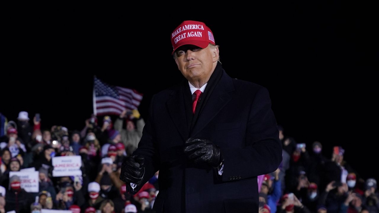 President Donald Trump stands on stage after a campaign rally at Gerald R. Ford International Airport in Grand Rapids, Mich. on Nov. 2, 2020. (AP Photo/Evan Vucci)