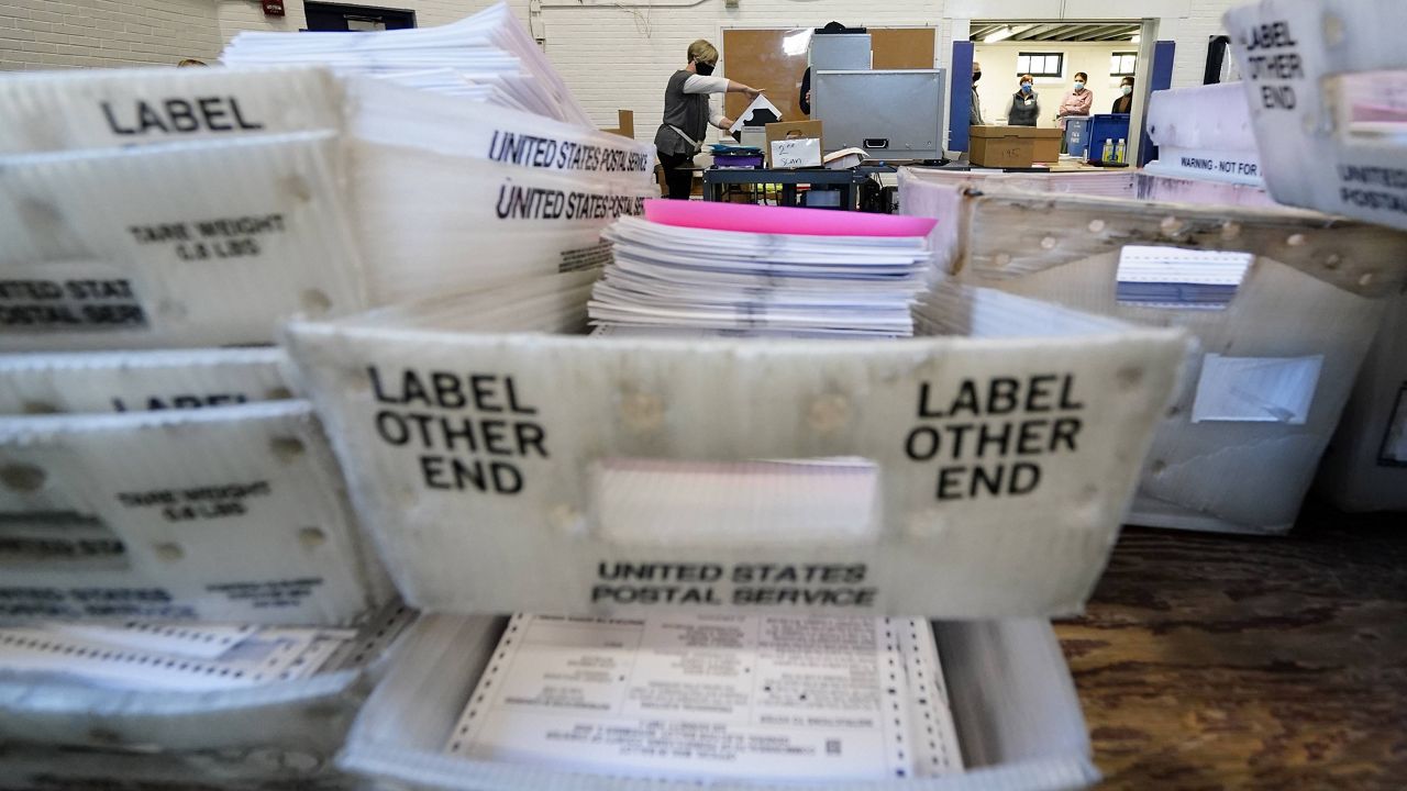 Election workers in Chester County, Pennsylvania, scan mail-in and absentee ballots on Nov. 4, 2020. (AP Photo/Matt Slocum)