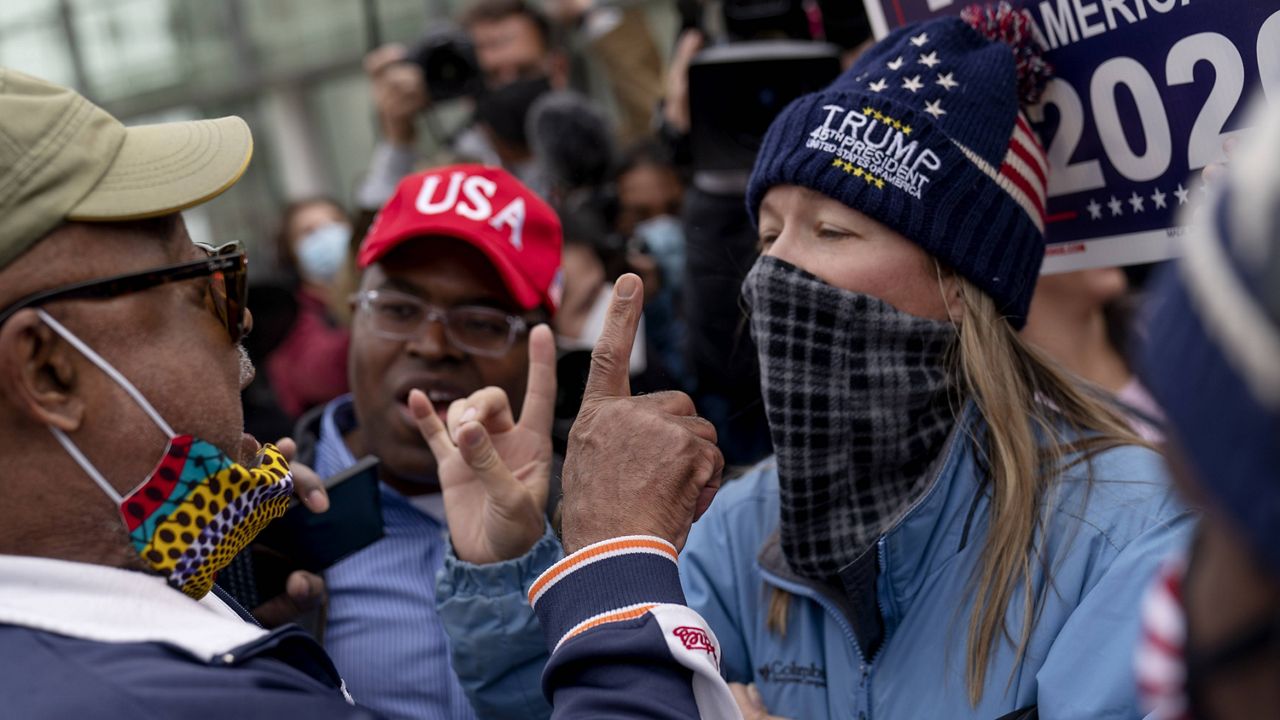 Trump supporters, right, argue with a counterprotester outside the central counting board at the TCF Center in Detroit on Thursday. (AP Photo/David Goldman)