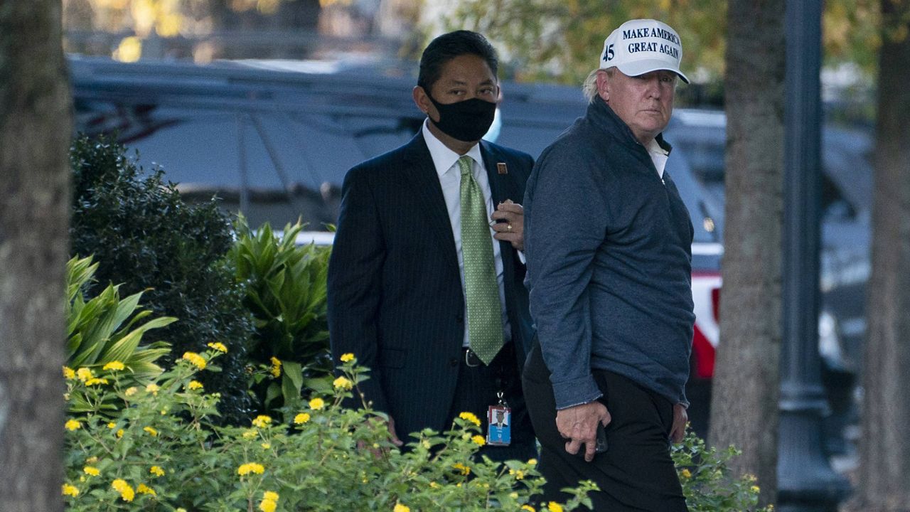 President Donald Trump returns to the White House after playing a round of golf, Saturday, Nov. 7, 2020, in Washington. (AP Photo/Evan Vucci)