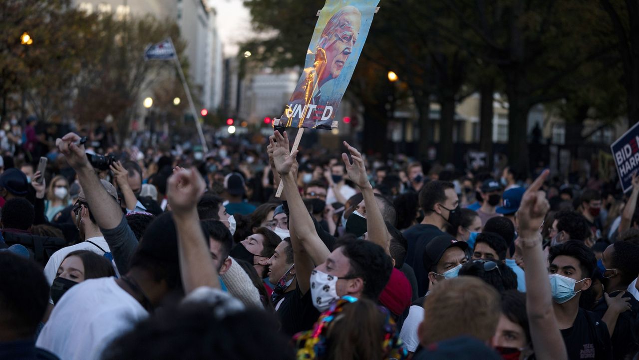 Supporters of President-elect Joe Biden gather near the White House to celebrate his election victory, Saturday, Nov. 7, 2020, in Washington. (AP Photo/Evan Vucci)