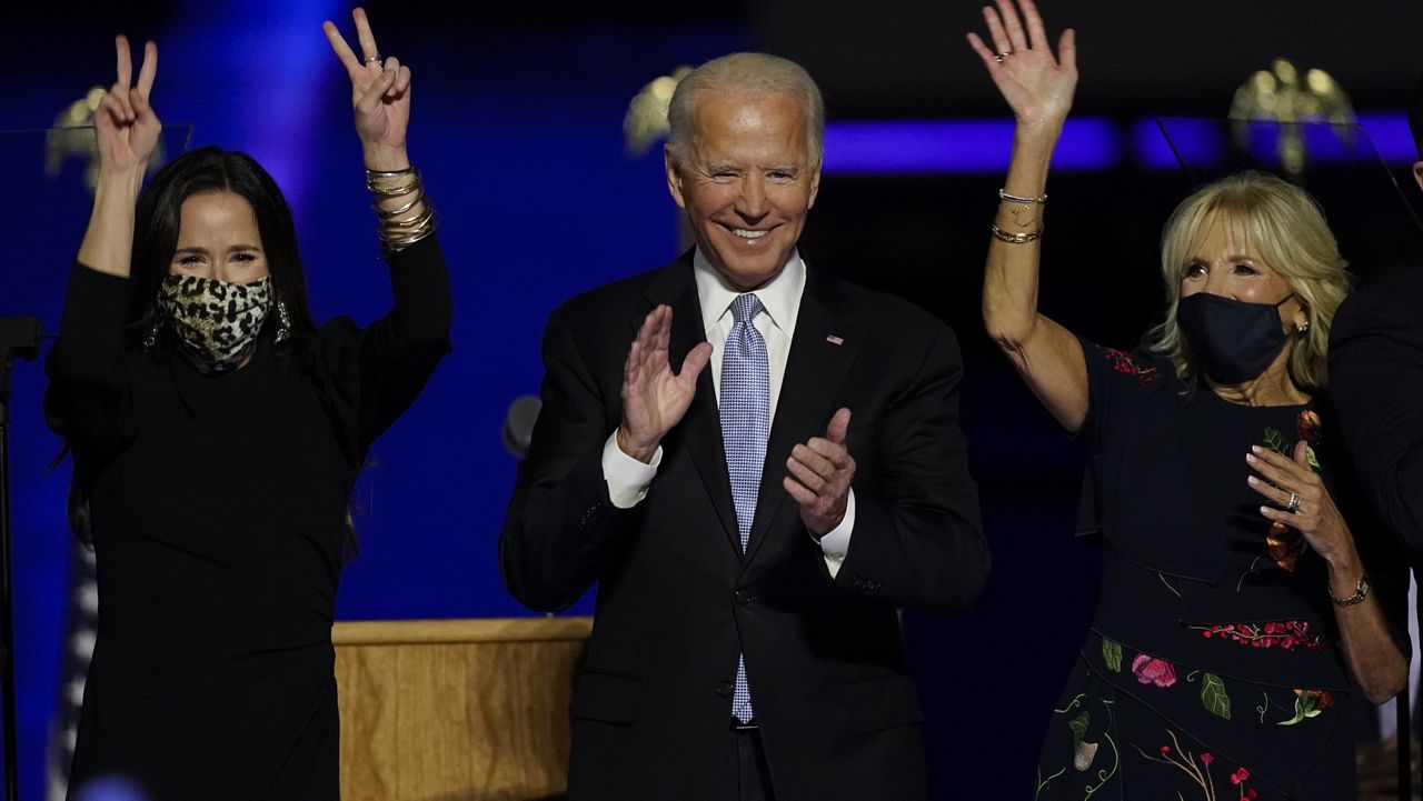 President-elect Joe Biden, his wife Jill Biden, and members of the Biden family, stand on stage Saturday, Nov. 7, 2020, in Wilmington, Del. (AP Photo/Andrew Harnik)