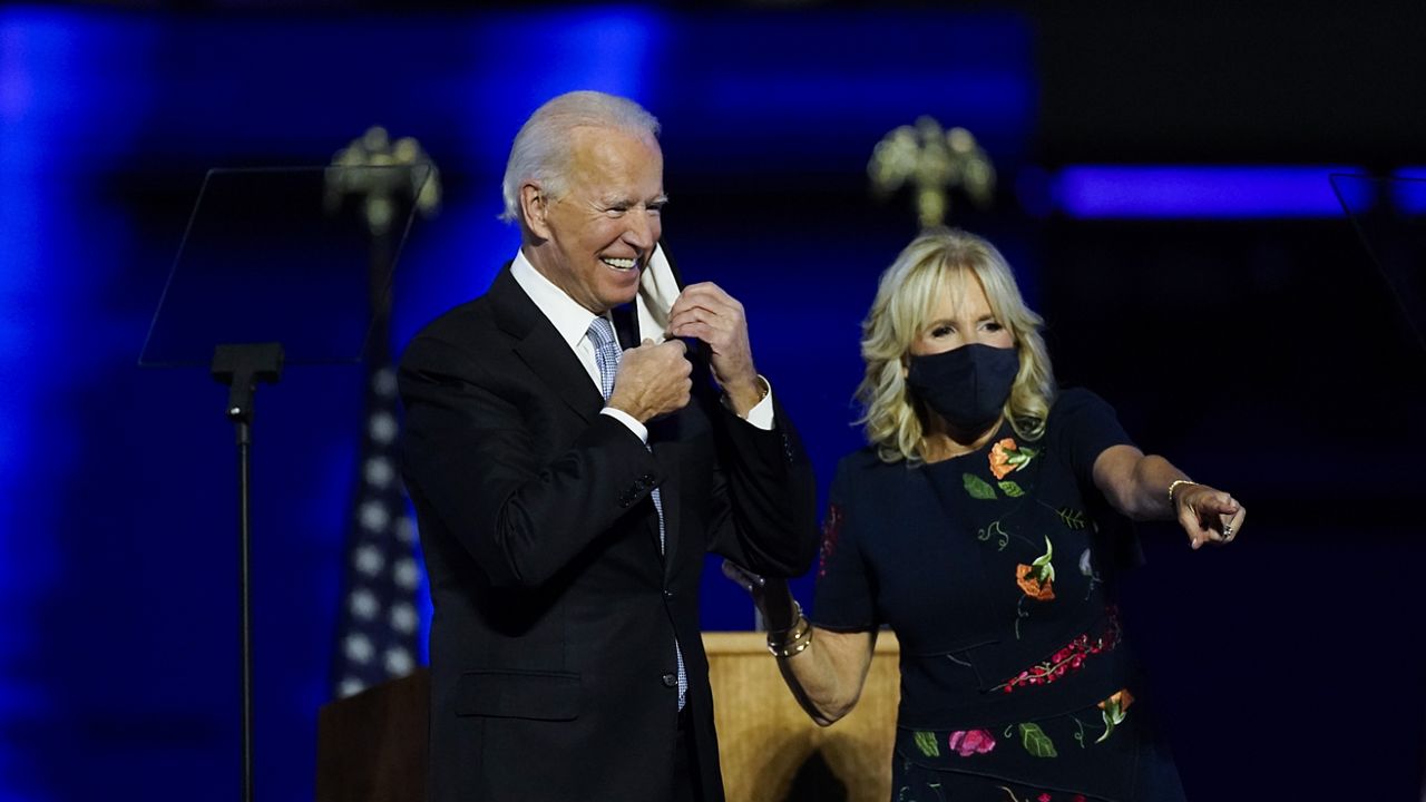 President-elect Joe Biden stands on stage with his wife Jill, Saturday, Nov. 7, 2020, in Wilmington, Del. (AP Photo/Andrew Harnik)