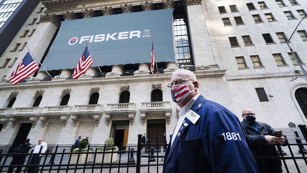 Stock trader Thomas Ferrigno arrives to work at the New York Stock Exchange on Nov. 9. (AP Photo/Mark Lennihan)