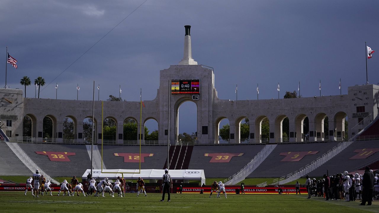 Rain clouds move through the area of Los Angeles Memorial Coliseum during the first half of an NCAA football game between Arizona State and Southern California Saturday, Nov. 7, 2020, in Los Angeles. (AP Photo/Ashley Landis)