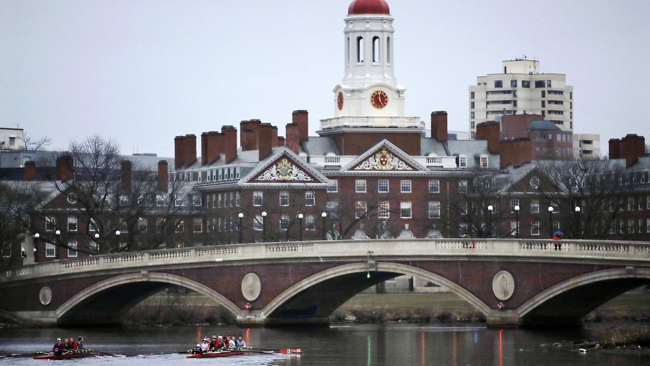 FILE - In this March 7, 2017, file photo, rowers paddle along the Charles River past the Harvard University campus in Cambridge, Mass. (AP Photo/Charles Krupa, File)