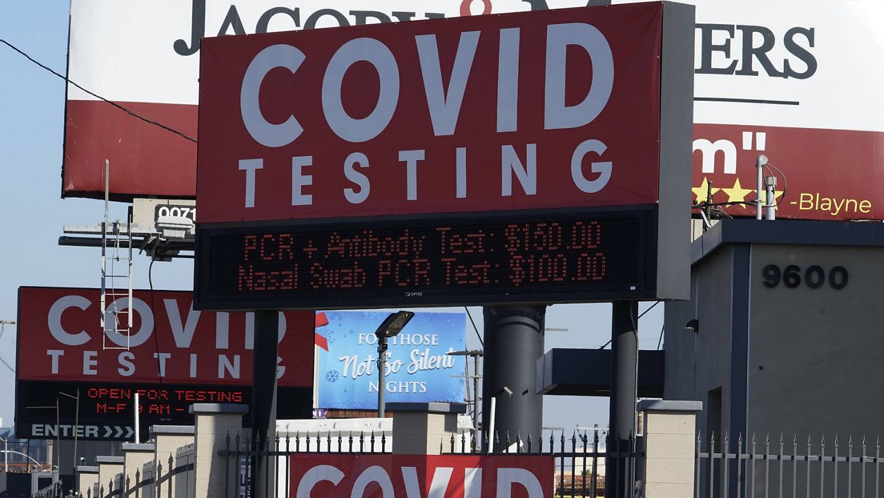 Advertisements for Covid-19 testing ares posted outside Los Angeles International Airport in Los Angeles, Friday, Nov. 13, 2020. (AP Photo/Damian Dovarganes)