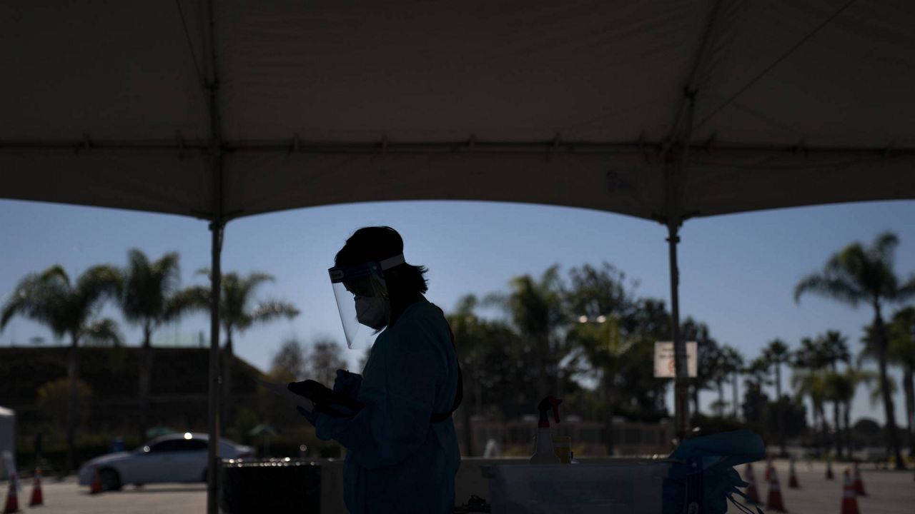 Medical assistant Linh Nguyen works at a COVID-19 testing site set up at the OC Fairgrounds in Costa Mesa, Calif., Nov. 16, 2020. (AP/Jae C. Hong)