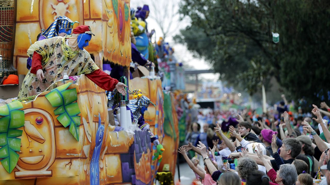 In this Feb. 11, 2018, file photo, float riders toss beads and trinkets during the Krewe of Thoth Mardi Gras parade in New Orleans. (AP Photo/Gerald Herbert, File)