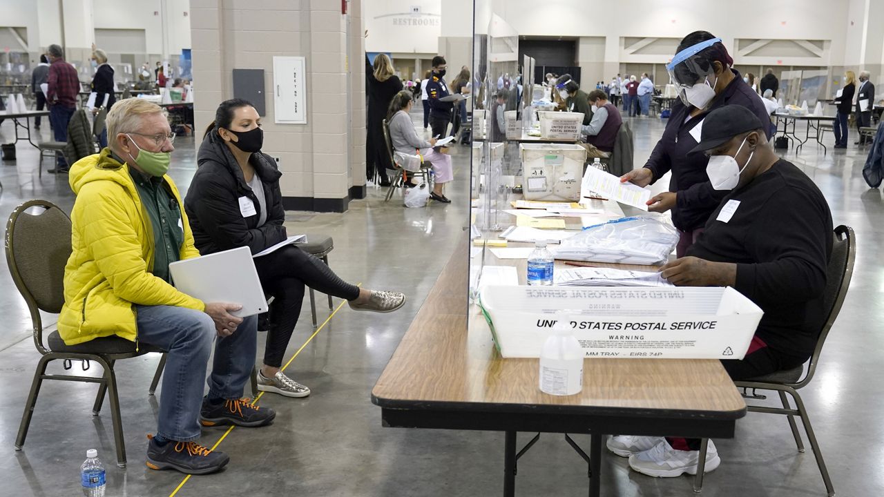 Election workers, right, verify ballotsElection workers, right, verify ballots as recount observers, left, watch during a Milwaukee hand recount of presidential votes at the Wisconsin Center, Friday, Nov. 20, 2020, in Milwaukee. (AP Photo/Nam Y. Huh) as recount observers, left, watch during a Milwaukee hand recount of presidential votes at the Wisconsin Center, Friday, Nov. 20, 2020, in Milwaukee. The recount of the presidential election in Wisconsin's two most heavily Democratic counties began Friday with President Donald Trump's campaign seeking to discard tens of thousands of absentee ballots that it alleged should not have been counted. (AP Photo/Nam Y. Huh)