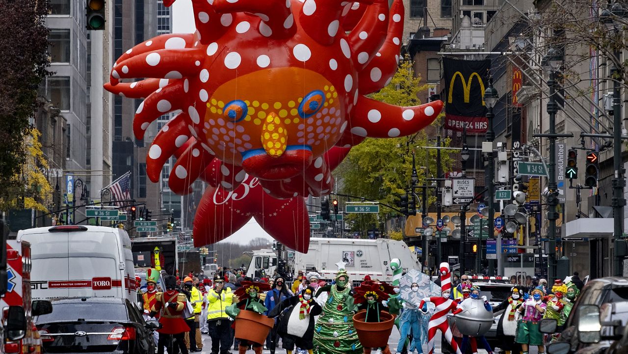 Participants dancing in the modified Macy's Thanksgiving Day Parade are seen from a barricade about two blocks away in New York, Thursday, Nov. 26, 2020. Due to the pandemic, crowds of onlookers were not allowed to attend the annual parade. (AP Photo/Craig Ruttle)