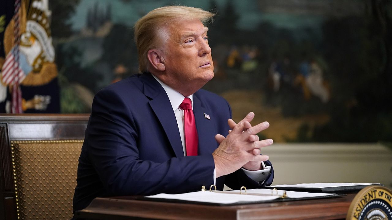 President Donald Trump participates in a video teleconference call with members of the military on Thanksgiving, Thursday, Nov. 26, 2020, at the White House in Washington. (AP Photo/Patrick Semansky)