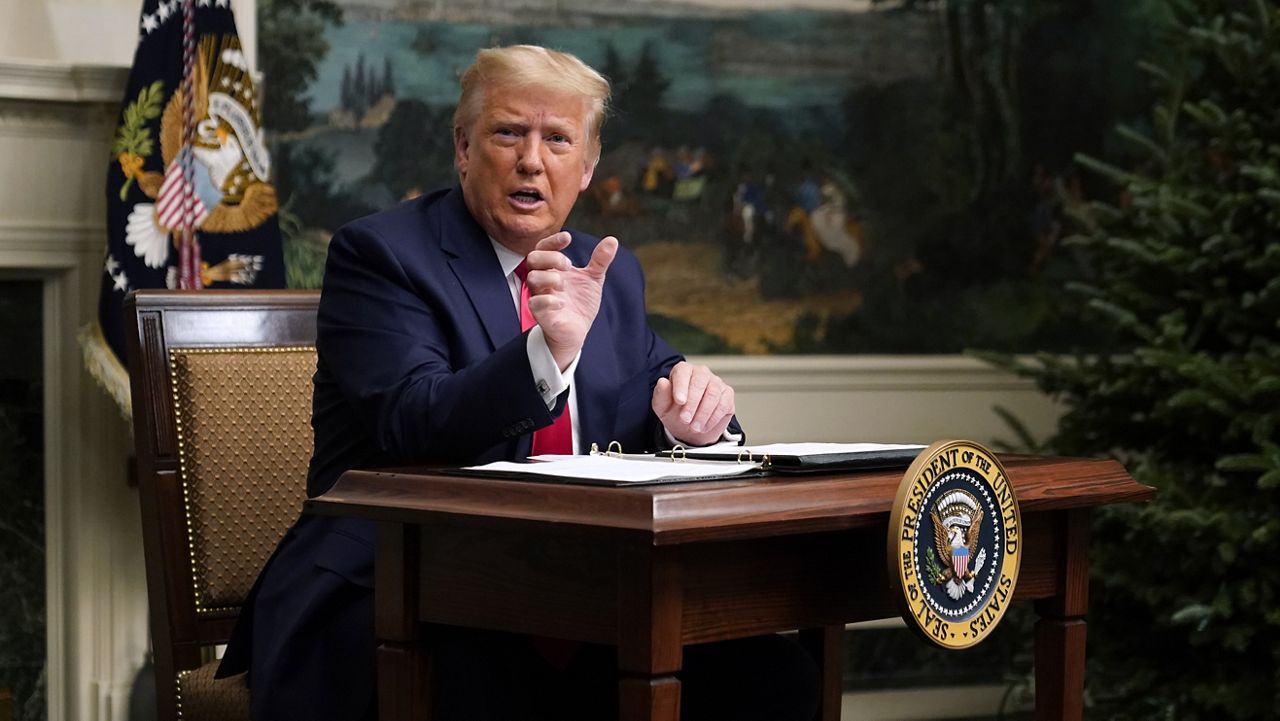 President Donald Trump speaks with reporters after participating in a video teleconference call with members of the military on Thanksgiving, Thursday, Nov. 26, 2020, at the White House in Washington. (AP Photo/Patrick Semansky)