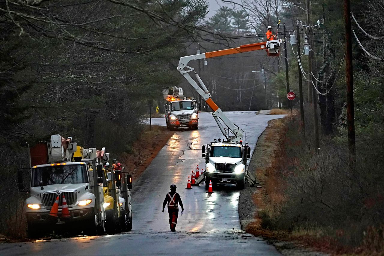 A crew from New Brunswick, Canada, works to restore power following a severe rain storm, Tuesday, Dec. 1, 2020, in Brunswick. At its peak on Saturday, Sept. 16, 2023, storm Lee knocked out electricity to over 100,000 in Maine. (AP Photo/Robert F. Bukaty)