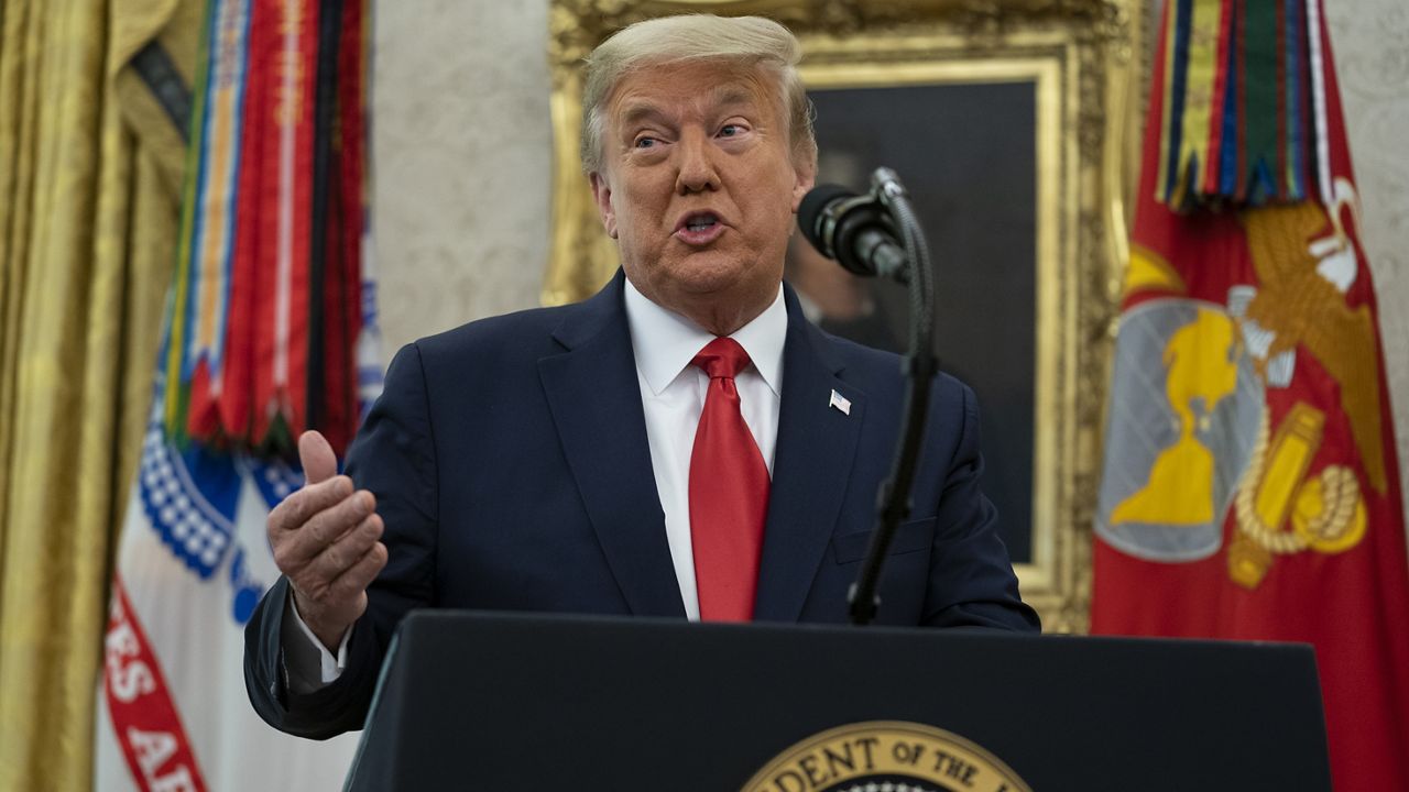 President Donald Trump speaks during a ceremony to present the Presidential Medal of Freedom to former football coach Lou Holtz, in the Oval Office of the White House, Thursday, Dec. 3, 2020, in Washington. (AP Photo/Evan Vucci)
