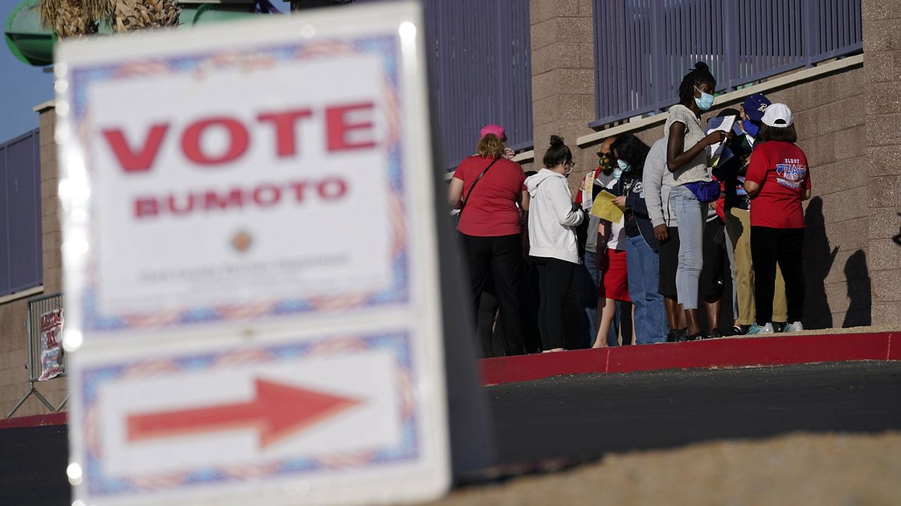 People wait in line to vote at a polling place in Las Vegas on Nov. 3, 2020. (AP Photo/John Locher, File)