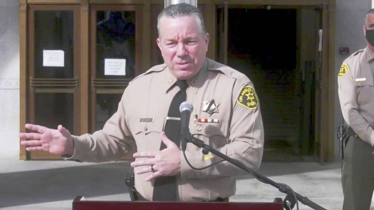 This photo from L.A. County Sheriff's Office streaming video shows Sheriff Alex Villaneuva discussing the arrest of nearly 160 people at a party in Palmdale, at a news conference in L.A. Tuesday, Dec. 8, 2020. (L.A. County Sheriff's Office via AP)
