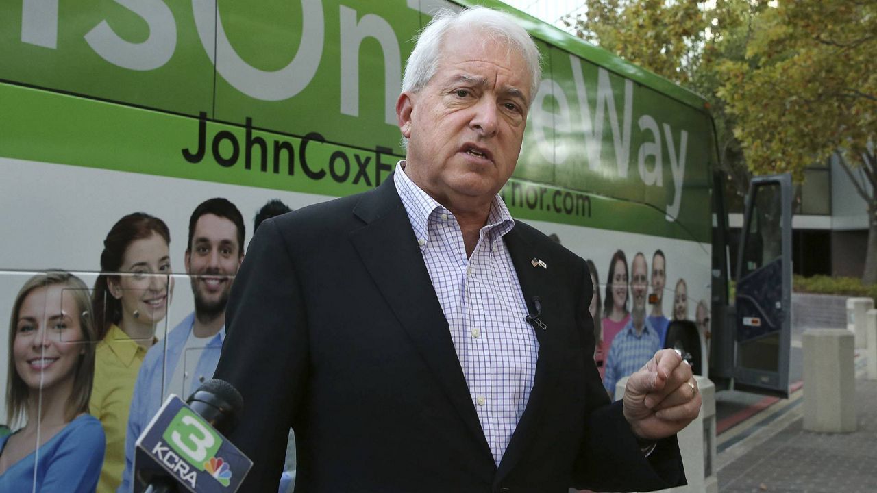 In this Nov. 1, 2018 file photo, Republican gubernatorial candidate John Cox talks to reporters before beginning a statewide bus tour in Sacramento, Calif. (AP Photo/Rich Pedroncelli)