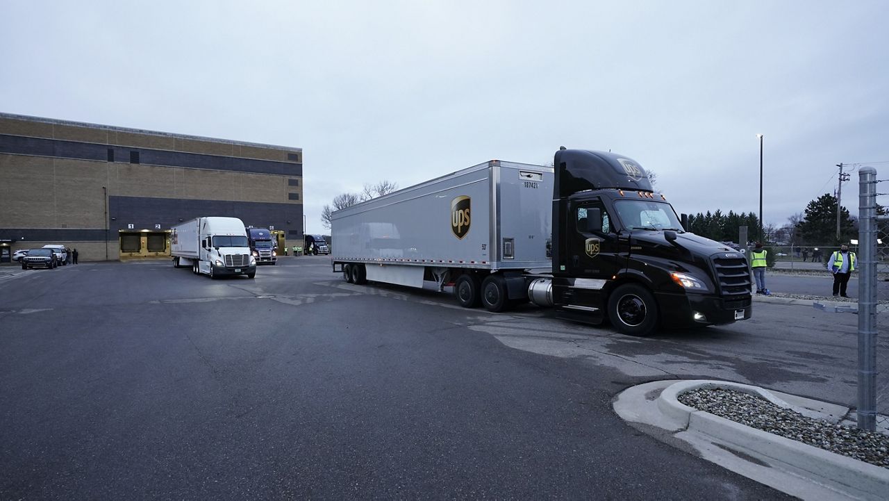 A truck loaded with the Pfizer-BioNTech COVID-19 vaccine leaves the Pfizer Global Supply Kalamazoo manufacturing plant in Portage, Mich., Sunday, Dec. 13, 2020. (AP Photo/Morry Gash, Pool)